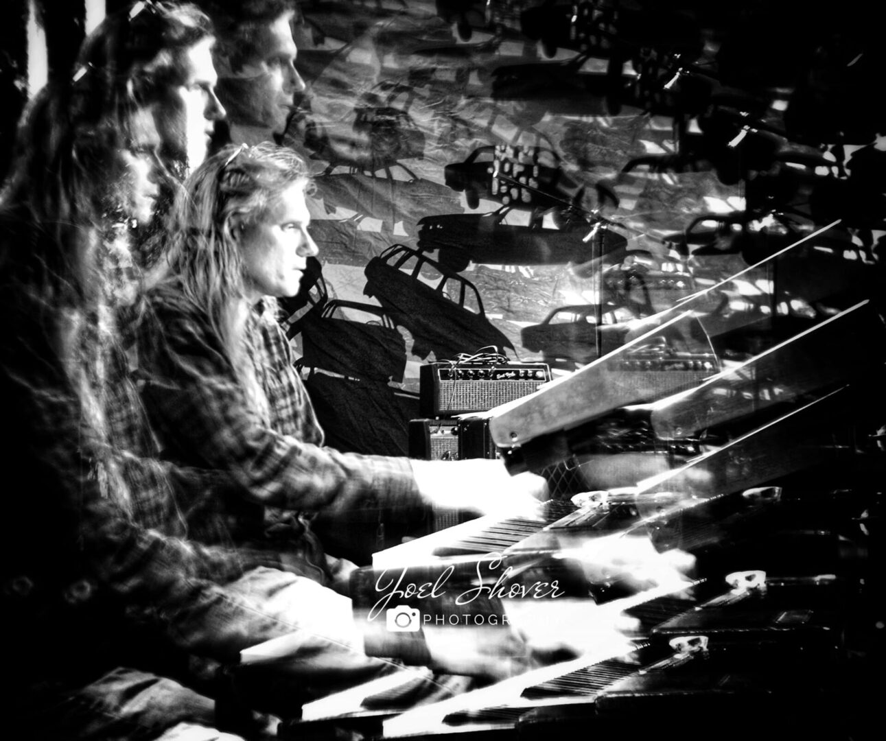 A group of people playing drums in a room.