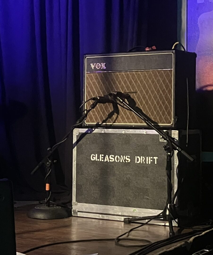 A guitar amp sitting on top of a stage.